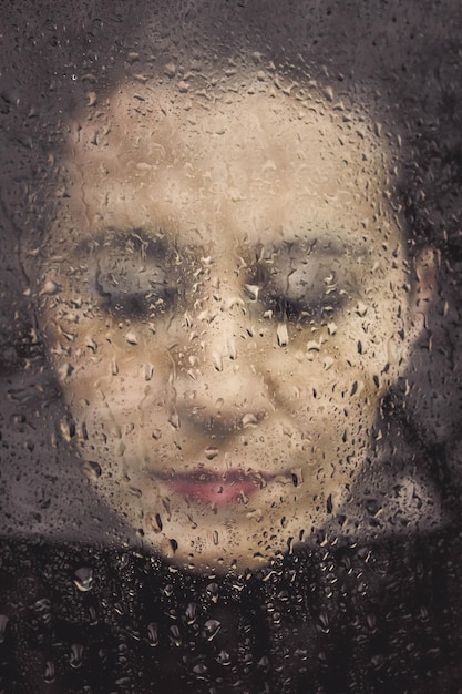Close-up shot of a character’s face in distress, with sweat and tears visible. The background is blurred, emphasizing the character’s emotional turmoil. The aesthetic is gritty and realistic.