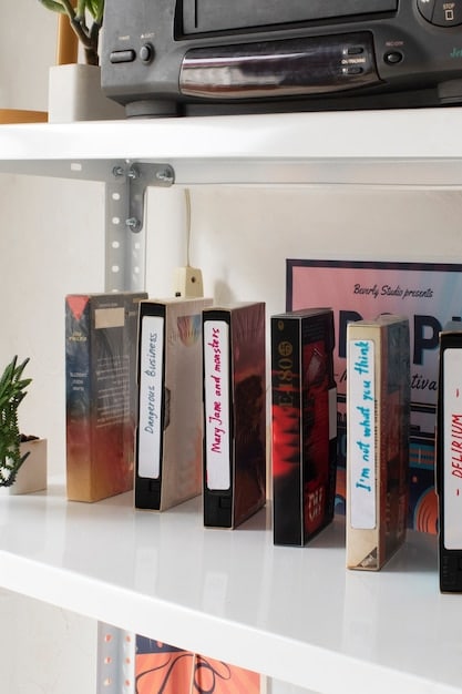 A close-up shot of several different shonen manga volumes displayed on a bookstore shelf. The volumes should represent a mix of classic and contemporary titles, with recognizable spines and cover art that can easily identify popular series within the genre.